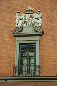 Window with luxurious decoration on bricks facade in Madrid Stock Photos