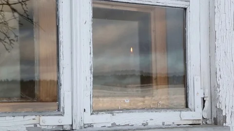 In the window, a man holds candle Stock Footage 98887167