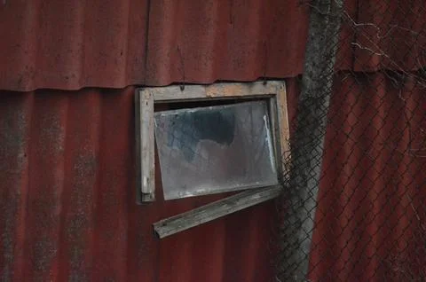 A window with a mirror in it is open and the mirror is cracked.  Stock Photos