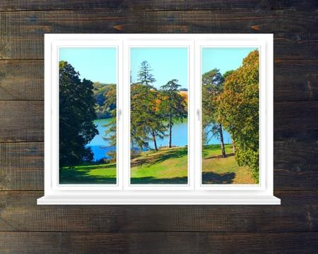 Window in modern room with panoramic view to forest lake Stock Photos