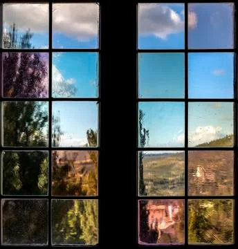 A window with multi-colored glass that overlooks a park or garden Stock Photos