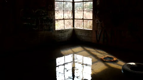 The window of an old building is reflected on the water of a basement, 4K Stock Footage 158712429