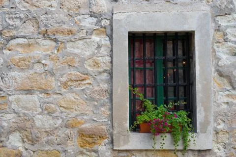 Window in the old stone wall Stock Photos
