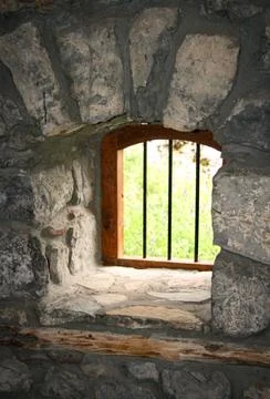 Window in the old  stone wall Stock Photos