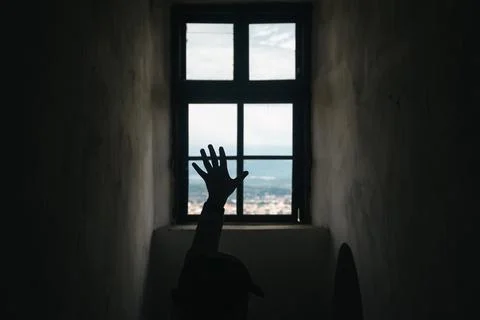 A window in an old tower overlooking the mountains. Stock Photos