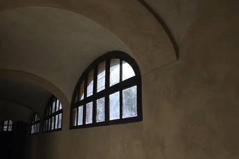 A window as the only light point in a basement Stock-Fotos