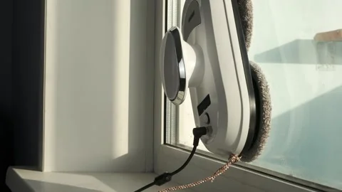 Window or mirror cleaning robot at home. The robot cleans the window Stock Footage 169382452
