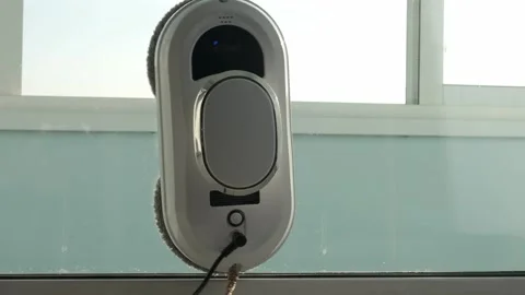 Window or mirror cleaning robot at home. The robot cleans the window in room. Stock Footage 170648846