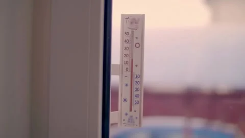 On the window, on the outside, there is a classic alcohol thermometer  Stock Footage 297823273