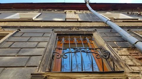 Window Pilaster and Downpipe of an Old Black Building Foto stock