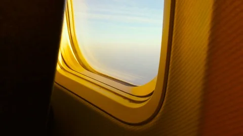 Window of a Plane and Sunset Sky and Clouds While Flying Video stock 72118205