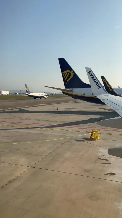 Window plane POV: Ryanair Planes Up Close from Grounded Perspective Stock Footage 244927561