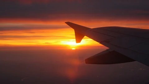 Window point of view of the sunrise in a plane, seeing wing aircraft. Paris Stock Footage 90741758