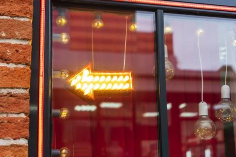 Window. Pointer in the shape of an arrow with bulbs that glow Stock Photos