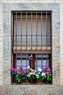 Window with pots and flowers in a village in central Spain, Agudo, Ciudad Real. Stock Photos