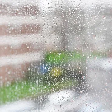 Window with rain drops, abstract background with selective focus Stock Photos
