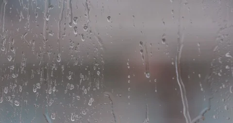 The window the rain is pouring down and the drops slowly run down my window Stock Footage 123505813