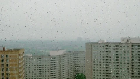 Window with raindrops and buildings Stock Footage 76051232