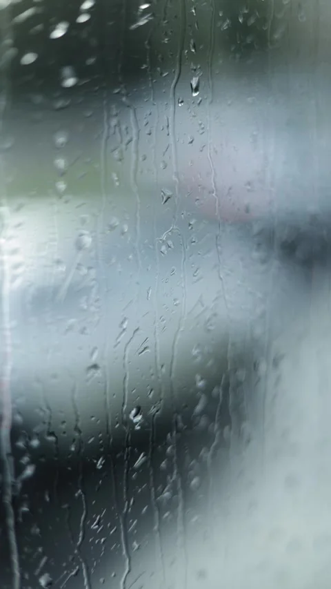 A Window With Raindrops, Blurred Background, Vertical Close-Up Shot Stock Footage 292326801