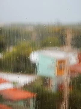 A window with raindrops on it and a blurry background Stock Photos