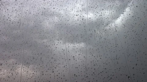Window raindrops in summer storm with grey clouds Stock Footage 200770804