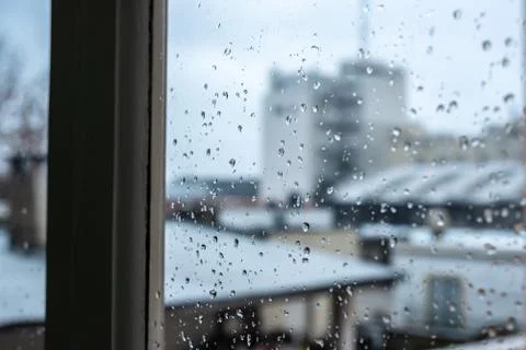 Window on a rainy day with small drops in it Stock Photos