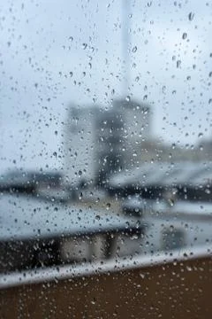 Window on a rainy day with small drops in it Stock Photos