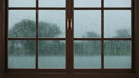A window in rainy weather. Raindrops dripping down the window pane. Loop video. Stock Footage 210815932