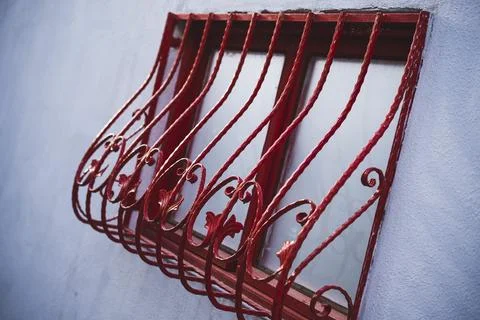 Window with red decorated bars Stock Photos