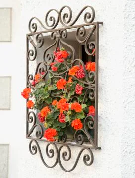 Window with red geraniums Stock Photos