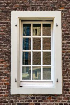 Window reflection of historic brick building Stock Photos