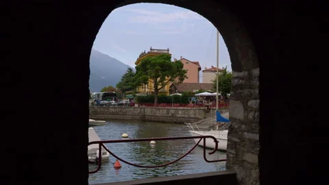 A window on the road wall with view to the Como lake and hotel Olivedo. Varenna Stock Footage 138611906