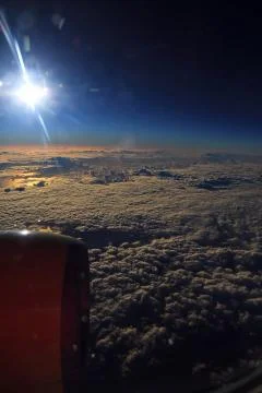 Window seat, a flight in the sunset Stock Photos