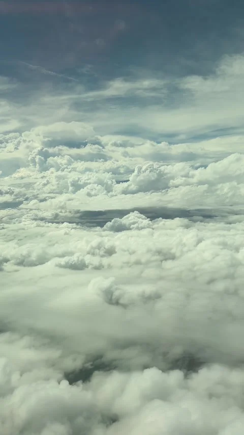 Window seat passenger point of view of aircraft flying above clouds. Stock Footage 334699627
