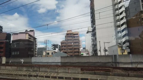 Window Seat POV View of Osaka City Buildings in Motion from Fast Moving JR Stock Footage 342296735