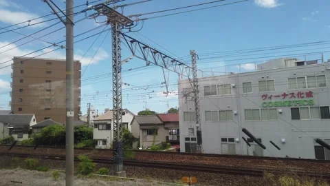 Window Seat POV View of Osaka City Buildings and Tracks in Motion from Moving Stock Footage 342296748