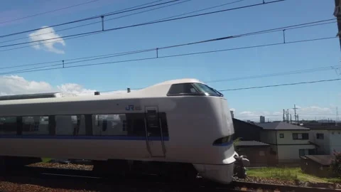 Window Seat POV View of Passing JR Limited Express Train in Motion Between Stock Footage 342296721