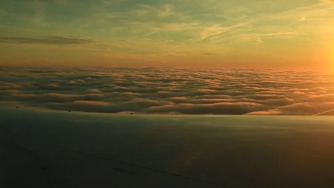 Window seat view of airline jet wing during a golden sunset. 動画素材 83653859