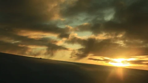 Window seat view of airline jet wing during a golden sunset. Vídeos de archivo 83654016