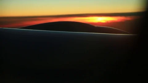 Window seat view of airline jet wing during a golden sunset. 스톡 동영상 83654106