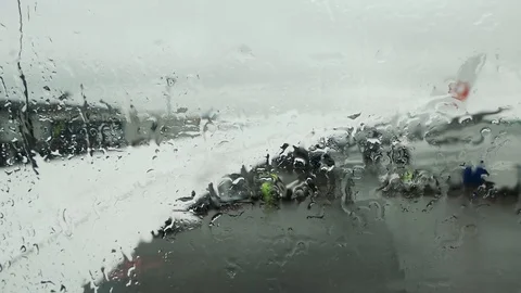 Window seat view in plane outside Rain drop on glass window in cloudy day. Stock Footage 120084123