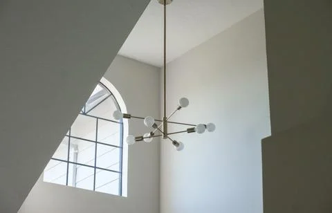 A window on the second floor and a light fixture Stock Photos