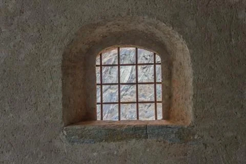 Window with security grating of an ancient castle 스톡 사진