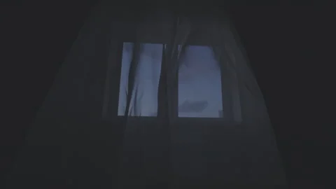 Window with sheer curtains blowing in evening breeze. Blue twilight sky visible Stock Footage 277467469
