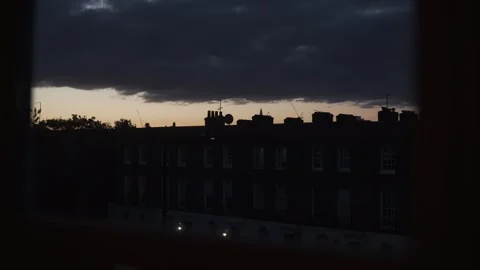 Window Shot of a Red Sunset Sky in Urban Settings, London, England Stock Footage 335077499