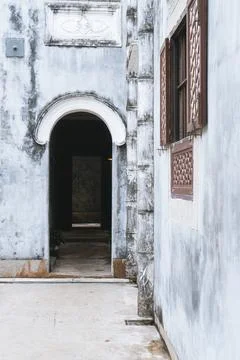 Window with shutters and bars in a building in Macau. Arched passage in a his Stock Photos