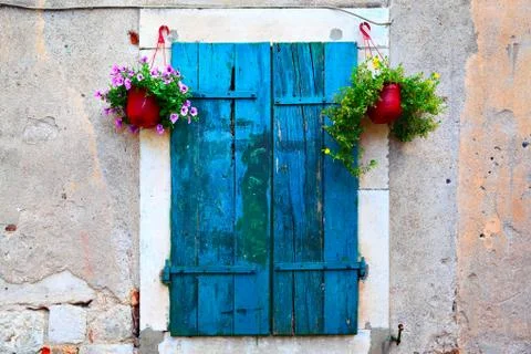 Window with shutters and flowerpots Stock Photos