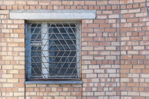 Window shutters and secure grating line, the artist plants. Stock Photos