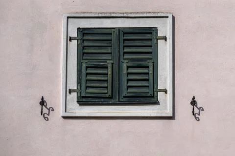 Window shutters on a pale wall. Фото
