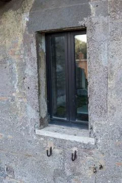 The window on the side of the concrete wall. Stock Photos